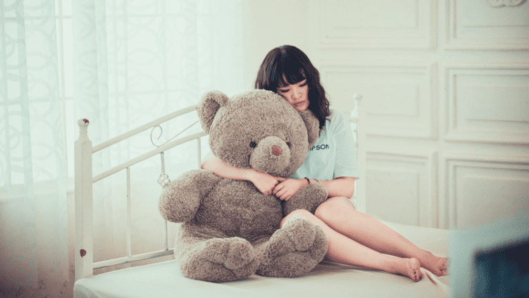 why do I feel bad all the time, girl with a teddy bear on the bed