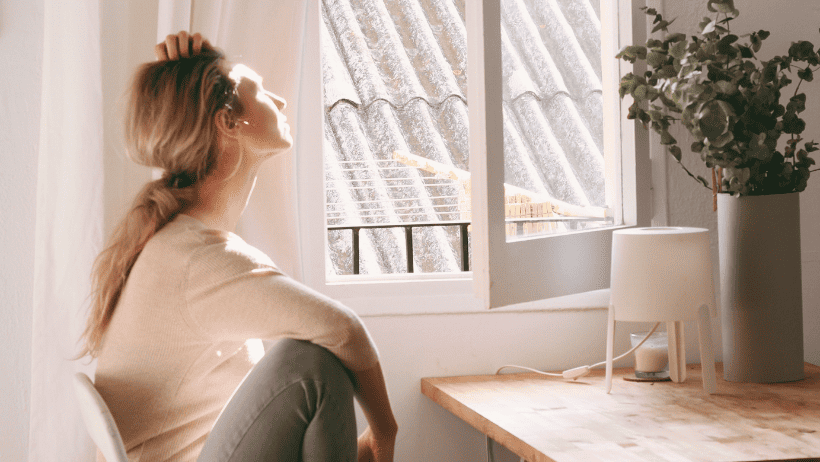 woman sitting by the window, self time, self compassion, self reflection